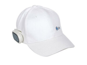 A picture of a white baseball cap with a small black oval device mounted to the right side of it. The mount is white.