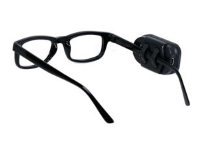 A picture of a black pair of glasses with a small black oval device clipped onto the right arm of the glasses.