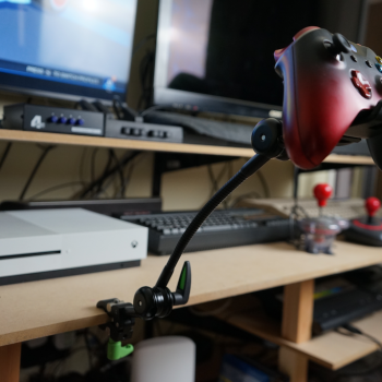 Xbox controller in red, mounted on the Rehadapt Wolf Mount gaming mount system.